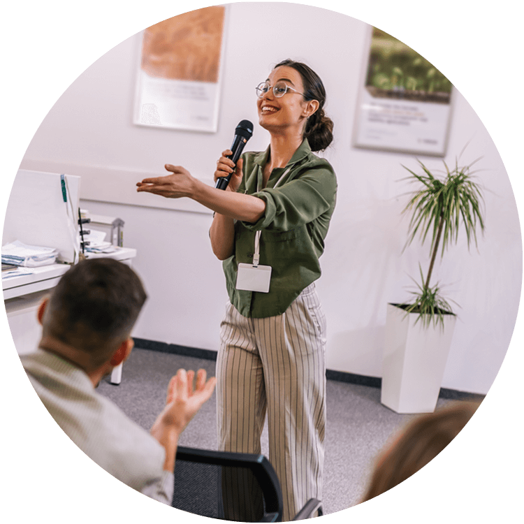 female speaking to room filled of educators