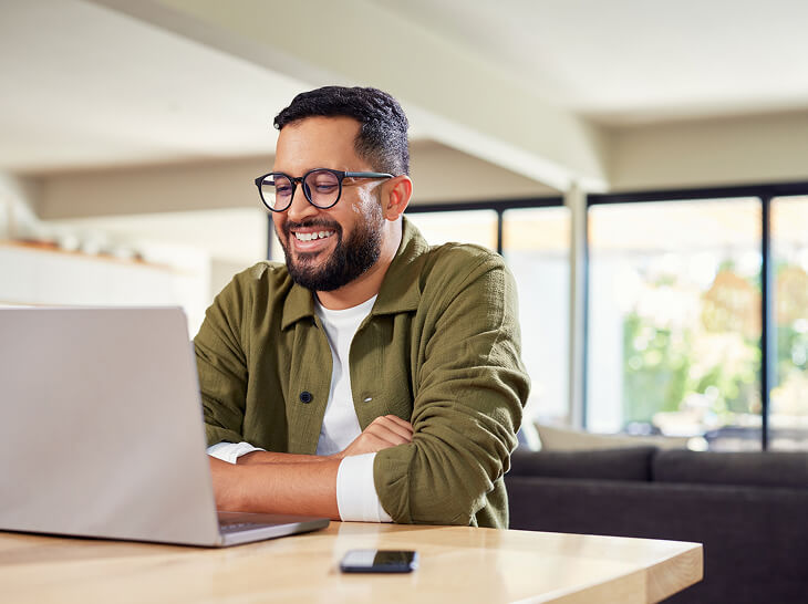 male teacher on laptop learning virtually